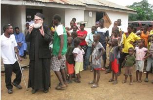 fr. themi talks with his flock